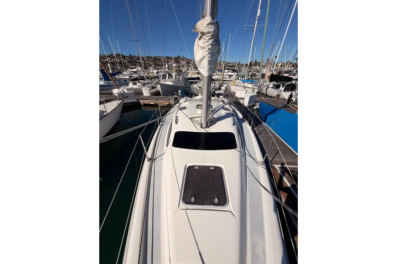 Slide: The Image of Hunter 336 sailboat from 1996 docked at a marina, surrounded by other boats. - 25