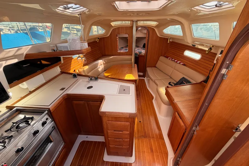 Slide: The Image of Interior of 1996 Hunter 336 sailboat with wood finish and cozy seating area. - 30