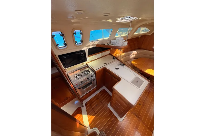 Slide: The Image of Interior of 1996 Hunter 336 sailboat with kitchen and seating area. - 31