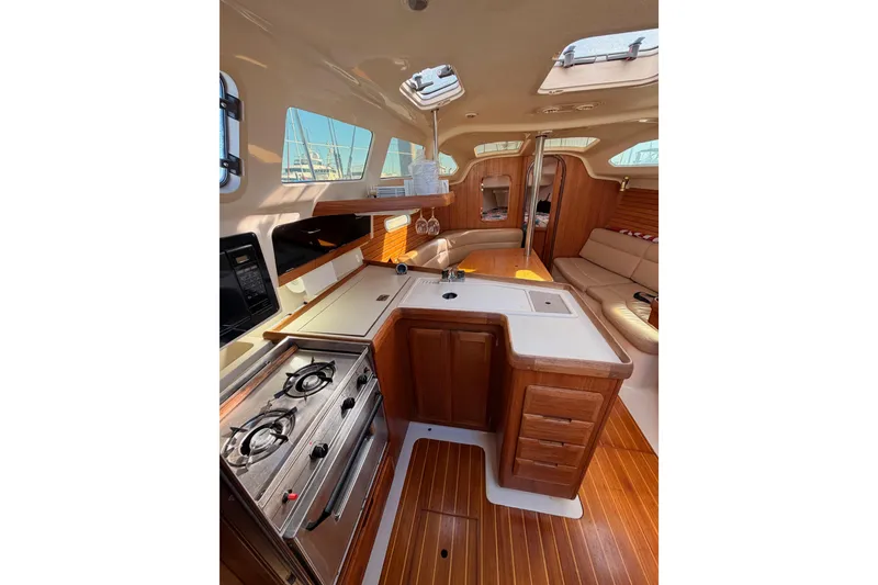 Slide: The Image of Interior of 1996 Hunter 336 sailboat with kitchen and seating area. - 33