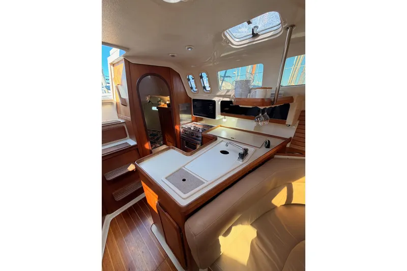 Slide: The Image of Interior of 1996 Hunter 336 sailboat with kitchen and seating area. - 34