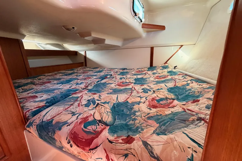 Slide: The Image of Cozy cabin interior of 1996 Hunter 336 sailboat with floral bedding. - 36