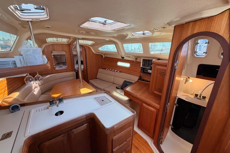 Slide: The Image of Interior of a 1996 Hunter 336 sailboat with wood finishes and cozy seating. - 38