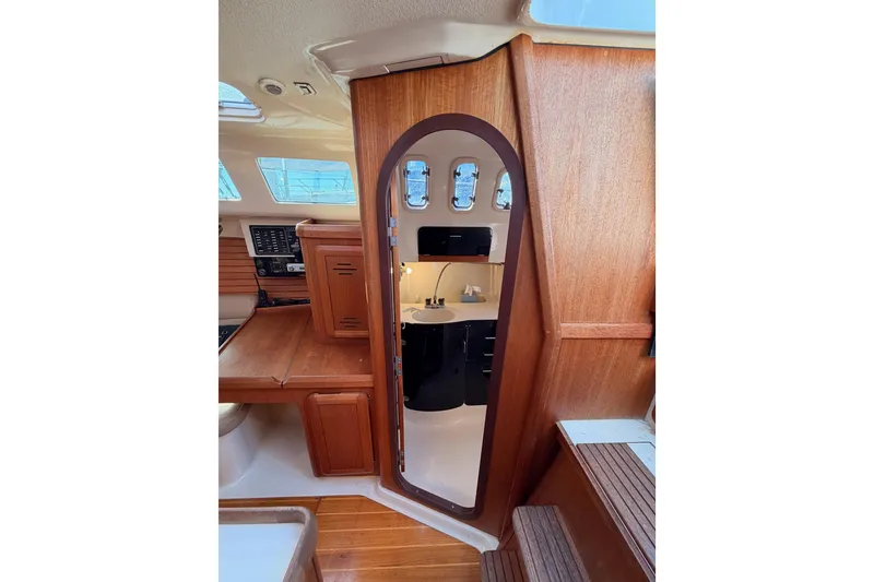Slide: The Image of Interior of a 1996 Hunter 336 sailboat with wooden cabinetry and compact design. - 39
