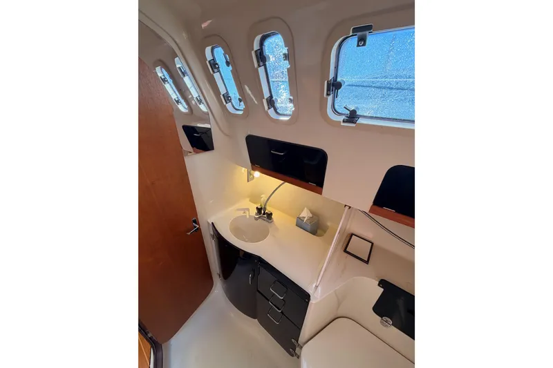 Slide: The Image of Interior of 1996 Hunter 336 sailboat bathroom with sink and porthole windows. - 42