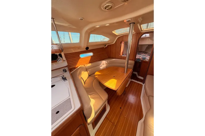 Slide: The Image of Interior of 1996 Hunter 336 sailboat with cozy seating and wooden table. - 44