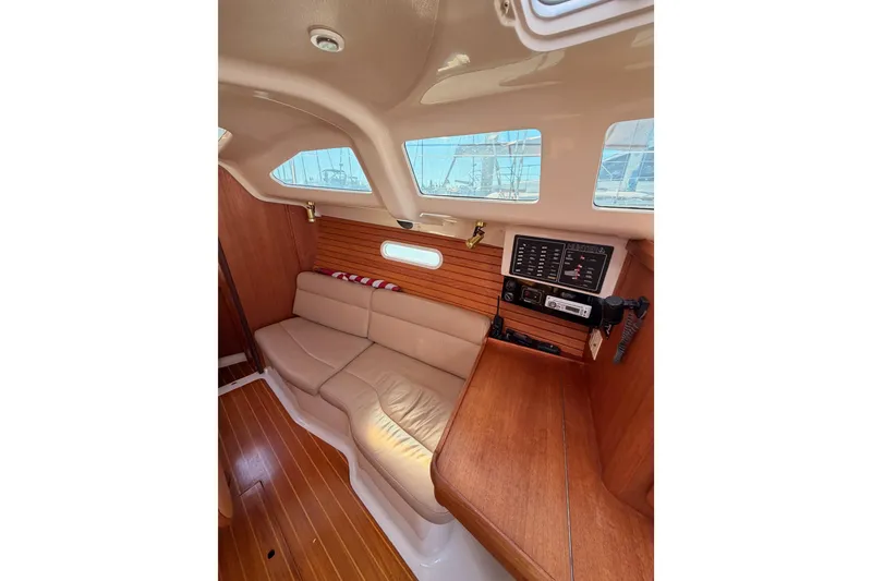 Slide: The Image of Interior of 1996 Hunter 336 sailboat with wood paneling and beige seating. - 45