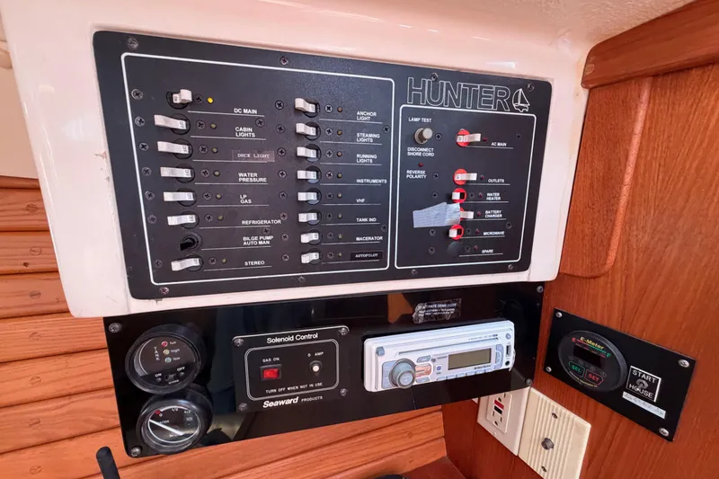 Slide: The Image of Control panel of a 1996 Hunter 336 sailboat with various switches and gauges. - 47