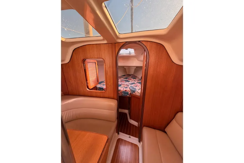 Slide: The Image of Interior of a 1996 Hunter 336 sailboat with wood paneling and cozy seating. - 48