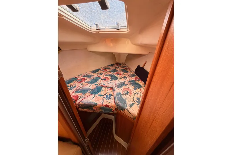 Slide: The Image of Cozy cabin interior of 1996 Hunter 336 sailboat with floral bedding and wooden accents. - 49