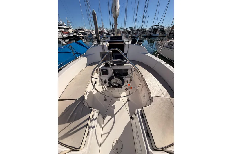 Slide: The Image of 1996 Hunter 336 sailboat cockpit with steering wheel, docked in marina. - 5