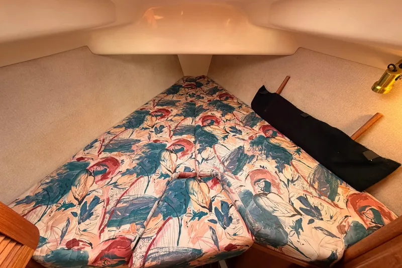 Slide: The Image of Cozy cabin interior of 1996 Hunter 336 sailboat with floral-patterned bedding. - 50