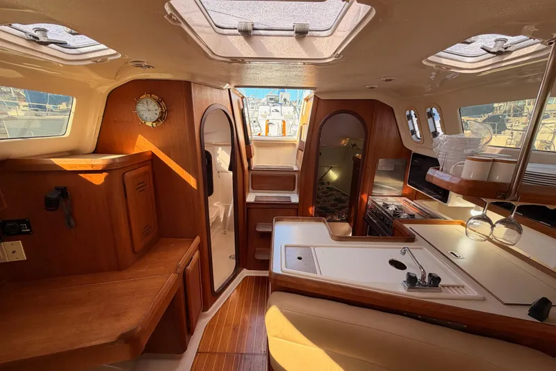 Slide: The Image of Interior of 1996 Hunter 336 sailboat with wood finish and modern amenities. - 56