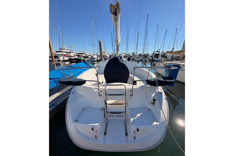 Slide: The Image of 1996 Hunter 336 sailboat docked in San Diego marina, surrounded by other boats. - 60