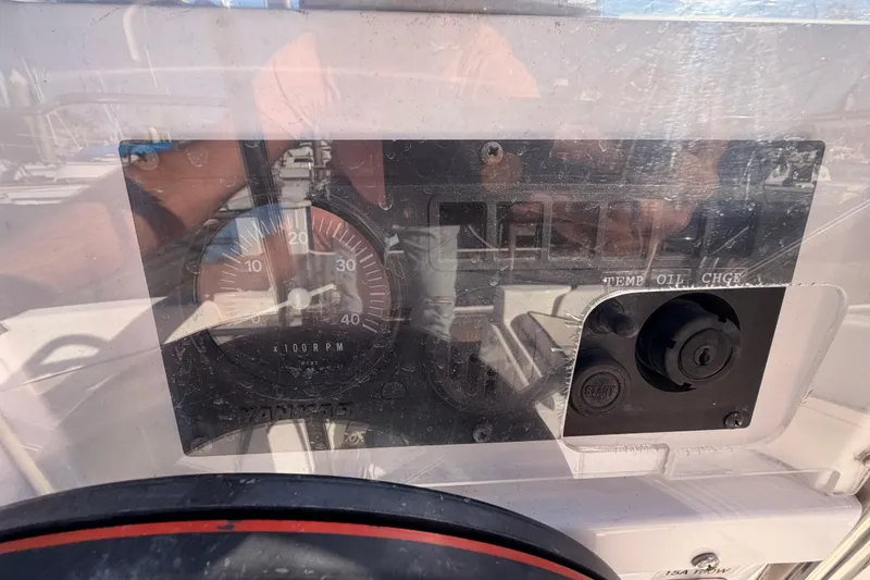 Slide: The Image of Control panel of a 1996 Hunter 336 sailboat, featuring RPM gauge and engine controls. - 9