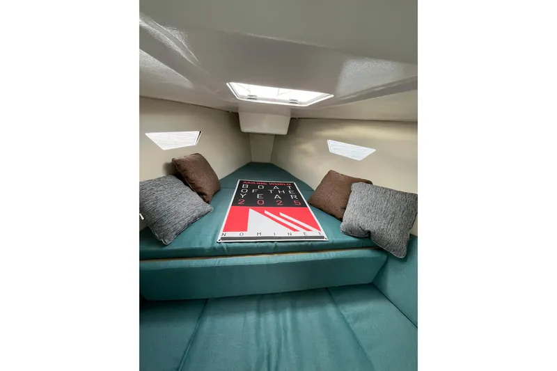 The Image of Cozy interior of 2025 Zonda Yachts Z28 with cushions and a skylight. - 1