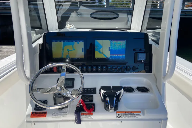 Slide: The Image of 2023 Sea Hunt Gamefish 27 helm with dual displays and modern controls. - 10