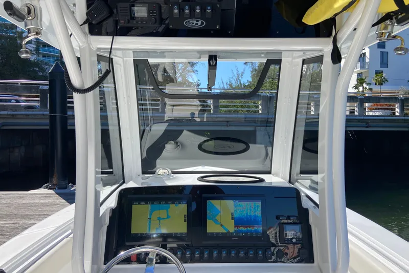 Slide: The Image of 2023 Sea Hunt Gamefish 27 dashboard with navigation screens and controls. - 12