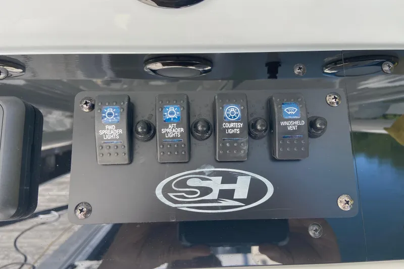Slide: The Image of Control panel of 2023 Sea Hunt Gamefish 27 with light and vent switches. - 15