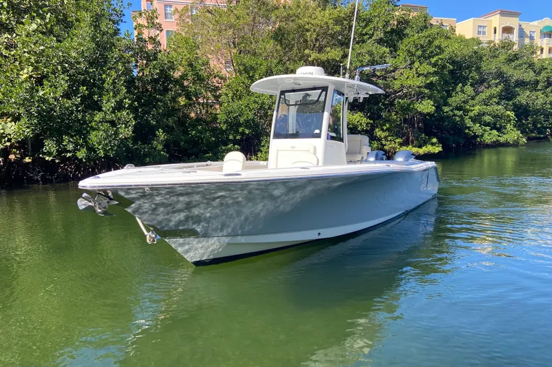 Slide: The Image of 2023 Sea Hunt Gamefish 27 boat with forward seating on calm water. - 2