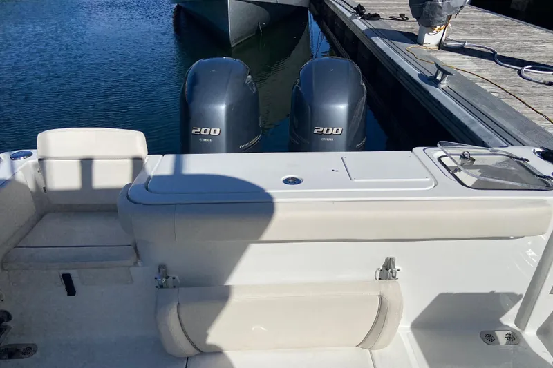 Slide: The Image of 2023 Sea Hunt Gamefish 27 boat with twin Yamaha 200 engines at dock. - 24