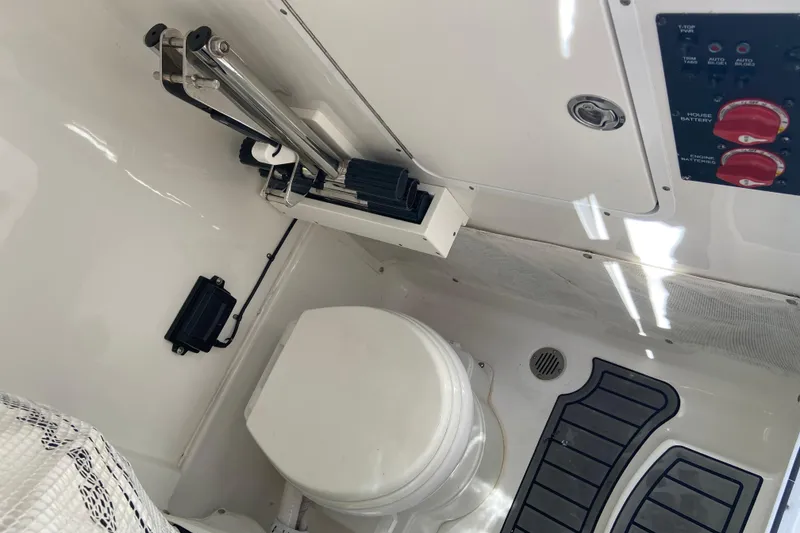 Slide: The Image of 2023 Sea Hunt Gamefish 27 Forward Seating boat interior with toilet and control panel. - 28