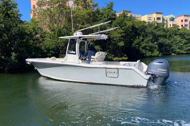 Slide: The Image of 2023 Sea Hunt Gamefish 27 boat with forward seating, cruising on a scenic waterway. - 4