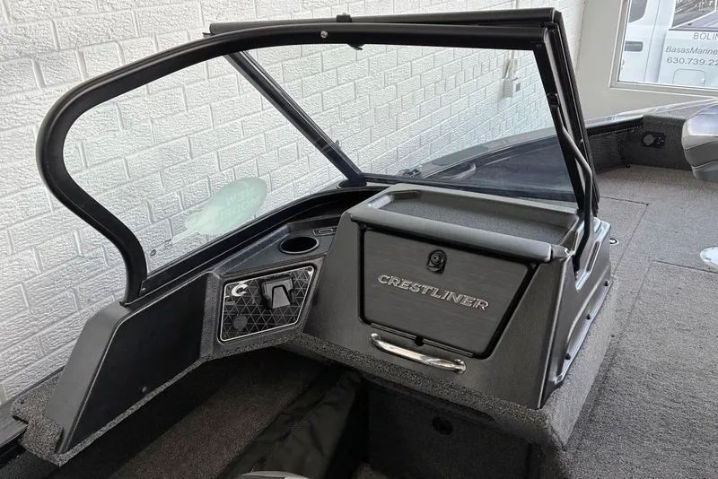 Slide: The Image of 2026 Crestliner 2050 Fish Hawk boat interior with windshield and storage compartment. - 6