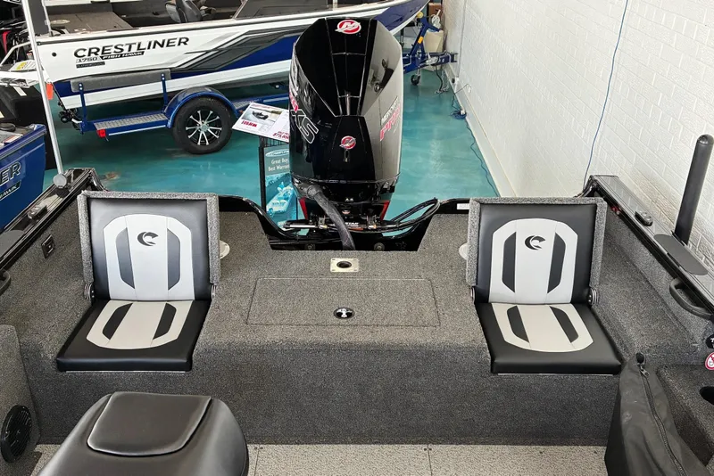 Slide: The Image of 2026 Crestliner 2050 Fish Hawk boat interior with seating and motor. - 8