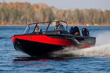 Slide: The Image of Manufacturer Provided Image: 2026 Crestliner 2050 Fish Hawk boat cruising on a lake with scenic forest backdrop. - 9