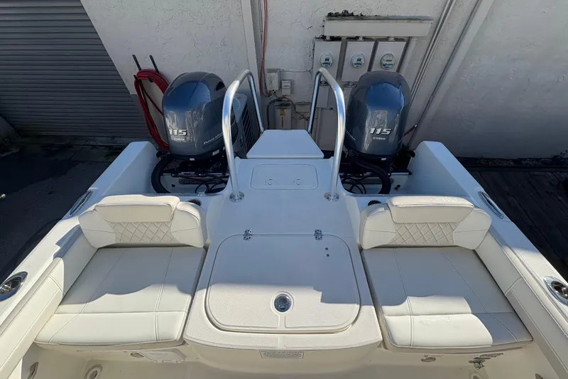 Slide: The Image of 2025 World Cat 230 DC boat with twin Yamaha 115 engines, featuring spacious seating. - 4