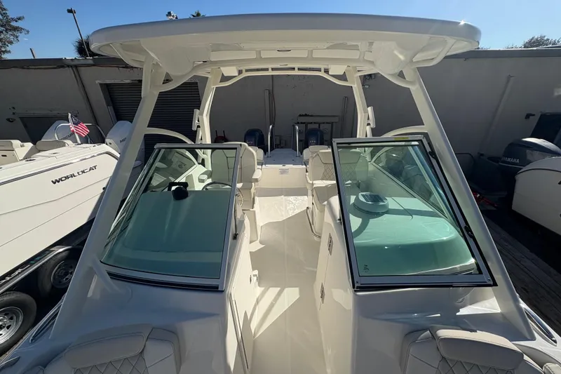 Slide: The Image of 2025 World Cat 230 DC boat with dual consoles and spacious seating. - 7