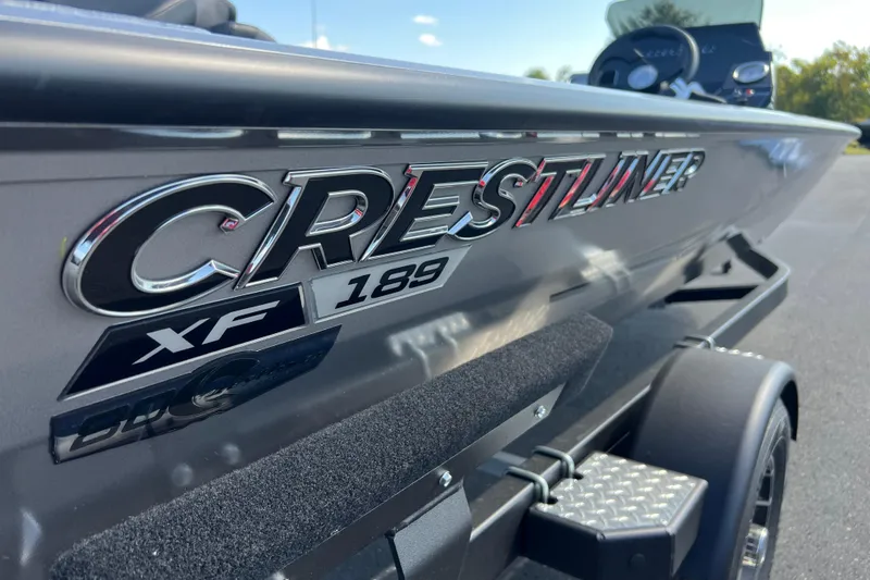 Slide: The Image of 2026 Crestliner XF 189 boat side view with logo and trailer. - 1