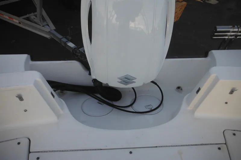 Slide: The Image of 2006 Triton 225 DC boat with Suzuki outboard motor, rear view. - 13