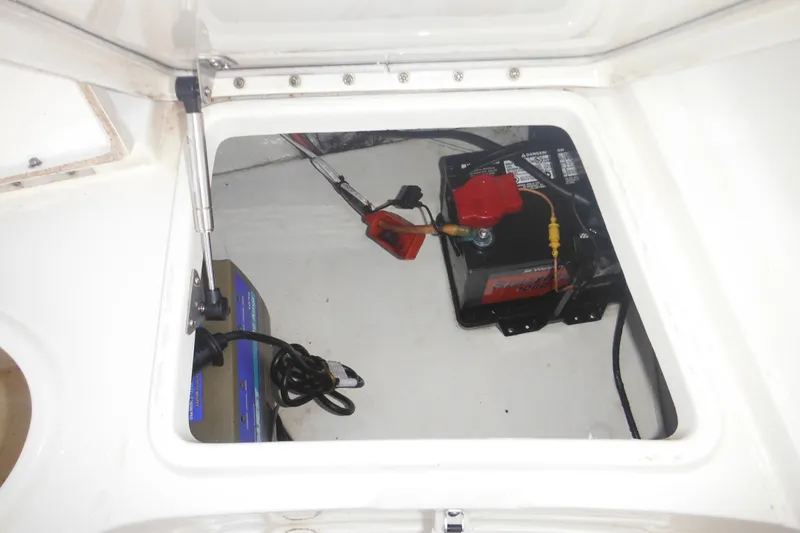 Slide: The Image of Open hatch of 2006 Triton 225 DC boat showing battery and wiring. - 20