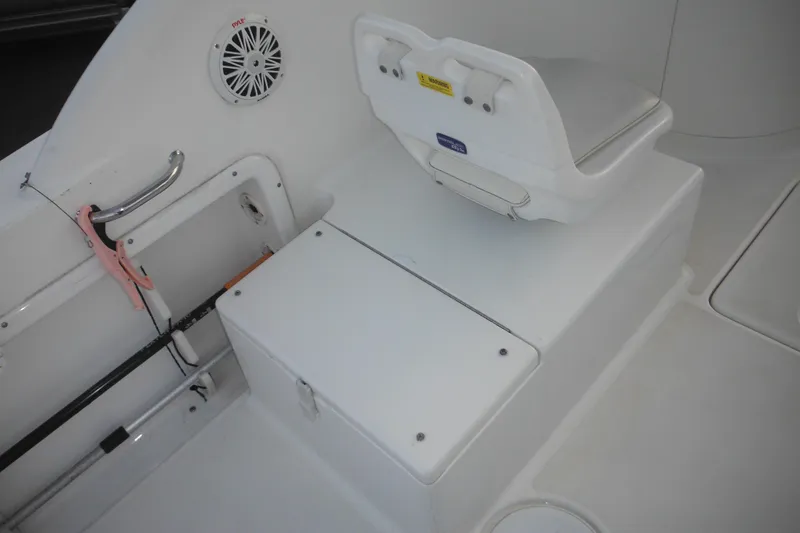 Slide: The Image of 2006 Triton 225 DC boat interior with seating and storage compartments. - 21