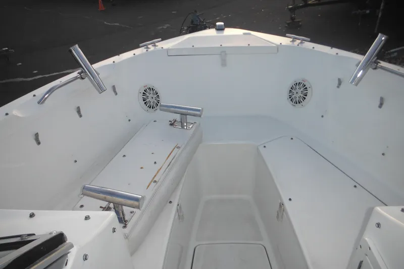 Slide: The Image of 2006 Triton 225 DC boat interior with rod holders and speakers. - 24