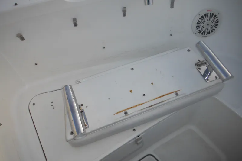 Slide: The Image of 2006 Triton 225 DC boat interior with foldable seat and speaker. - 28