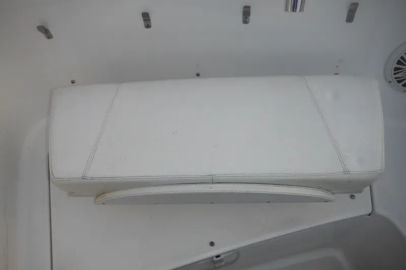 Slide: The Image of White cushioned seat on 2006 Triton 225 DC boat interior. - 29