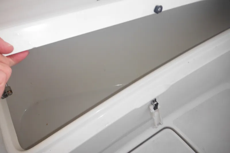 Slide: The Image of Open storage compartment on a 2006 Triton 225 DC boat. - 31