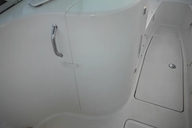 Slide: The Image of Interior view of a 2006 Triton 225 DC boat, featuring a sleek white design. - 37