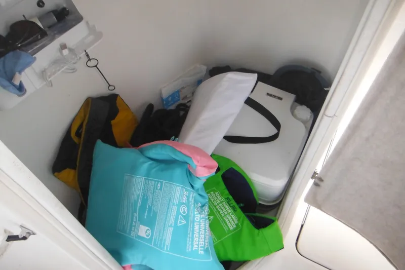 Slide: The Image of Storage compartment in a 2006 Triton 225 DC boat with life jackets and gear. - 39