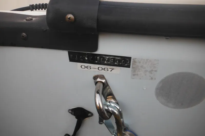 Slide: The Image of Close-up of a 2006 Triton 225 DC boat identification plate and hardware. - 4