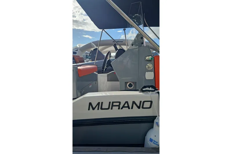 Slide: The Image of 2026 Murano Yachts Rovercat 205, side view with steering wheel and seating. - 5