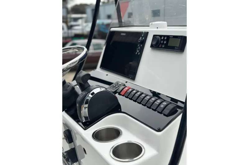 Slide: The Image of Control panel of a 2018 BlackJack 224 boat with steering wheel and switches. - 15