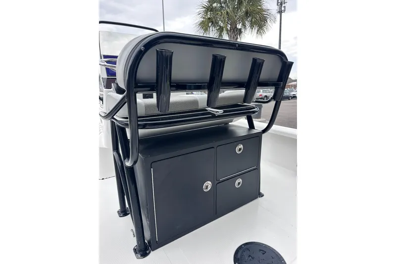 Slide: The Image of 2018 BlackJack 224 boat seat with storage compartments and rod holders. - 17