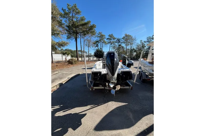 Slide: The Image of 2018 BlackJack 224 boat with outboard motor, parked on a sunny day. - 4