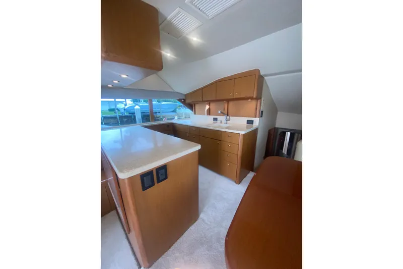 Slide: The Image of Luxurious 2002 Ocean Yacht Super Sport interior with modern kitchen and sleek cabinetry. - 3