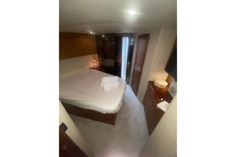 Slide: The Image of Luxurious bedroom interior of 2002 Ocean Yacht Super Sport, featuring cozy bed and elegant decor. - 8