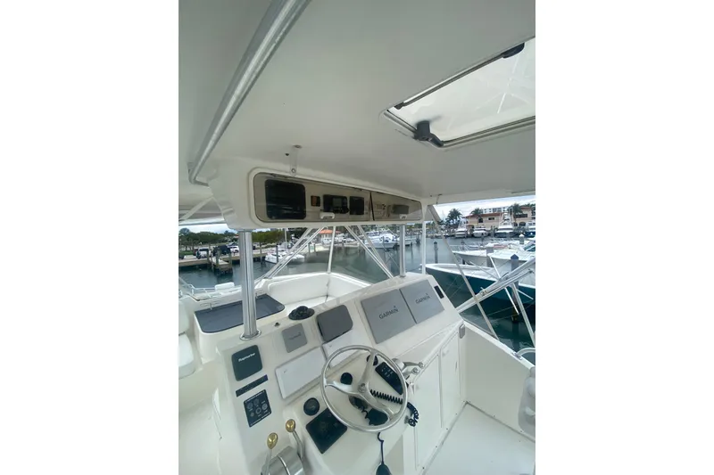Slide: The Image of 2002 Ocean Yacht Super Sport helm with Garmin navigation, docked at marina. - 12